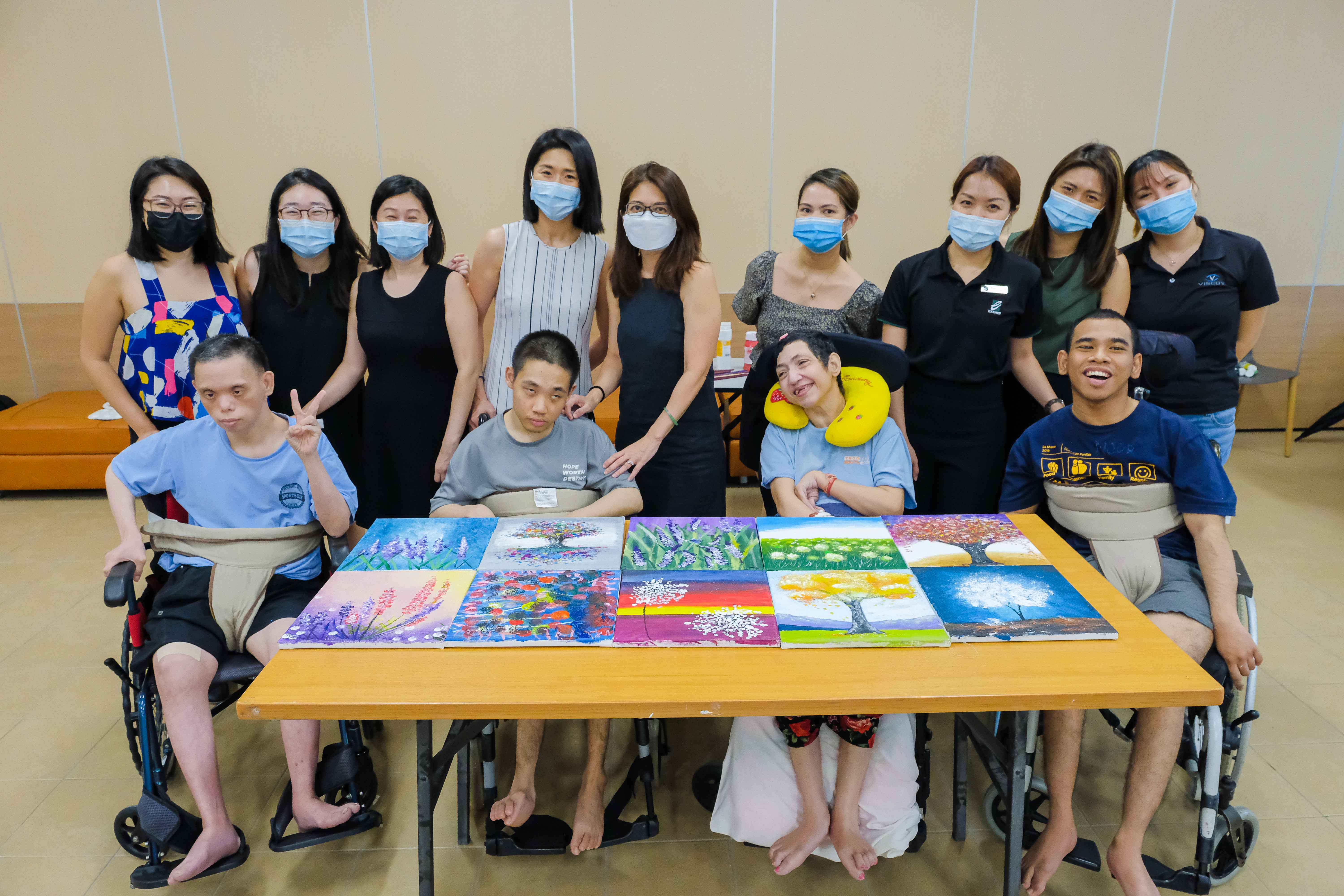 Art therapy volunteers and participants at the Home for the Disabled